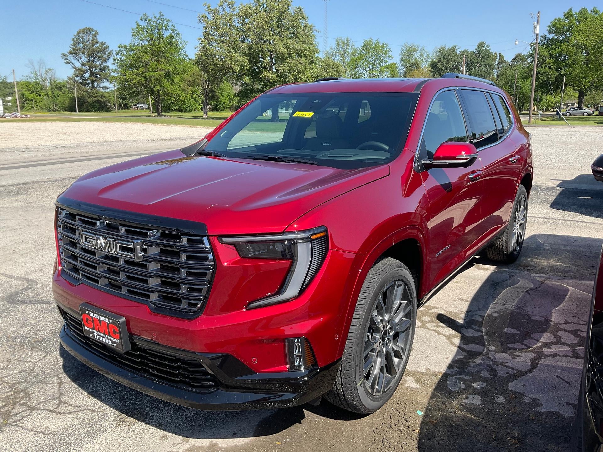 2026 GMC Acadia Denali Ultimate in Volcanic Red Tintcoat — front three-quarter view