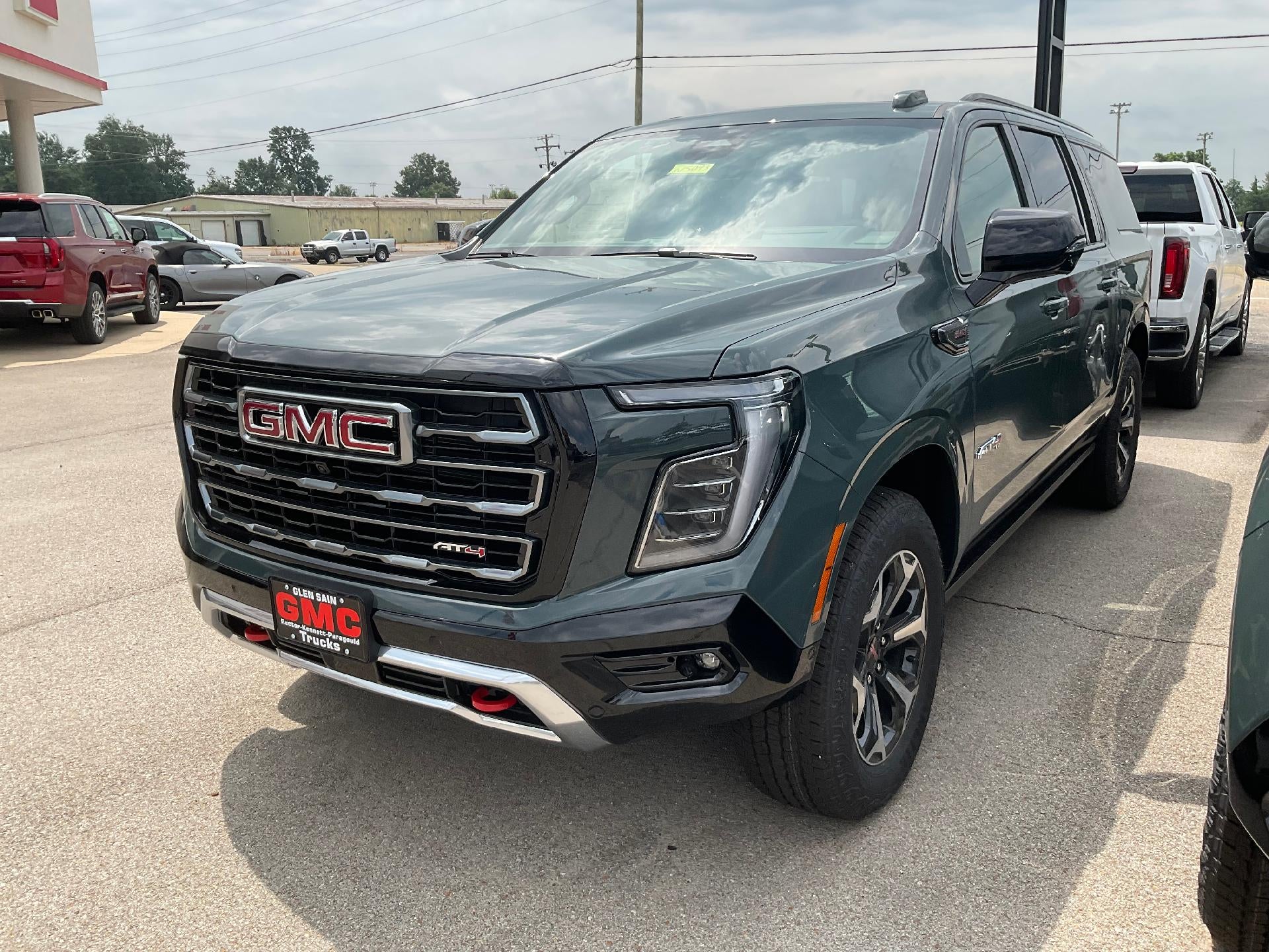 2026 GMC Yukon XL AT4 in Midnight Pine — front three-quarter view