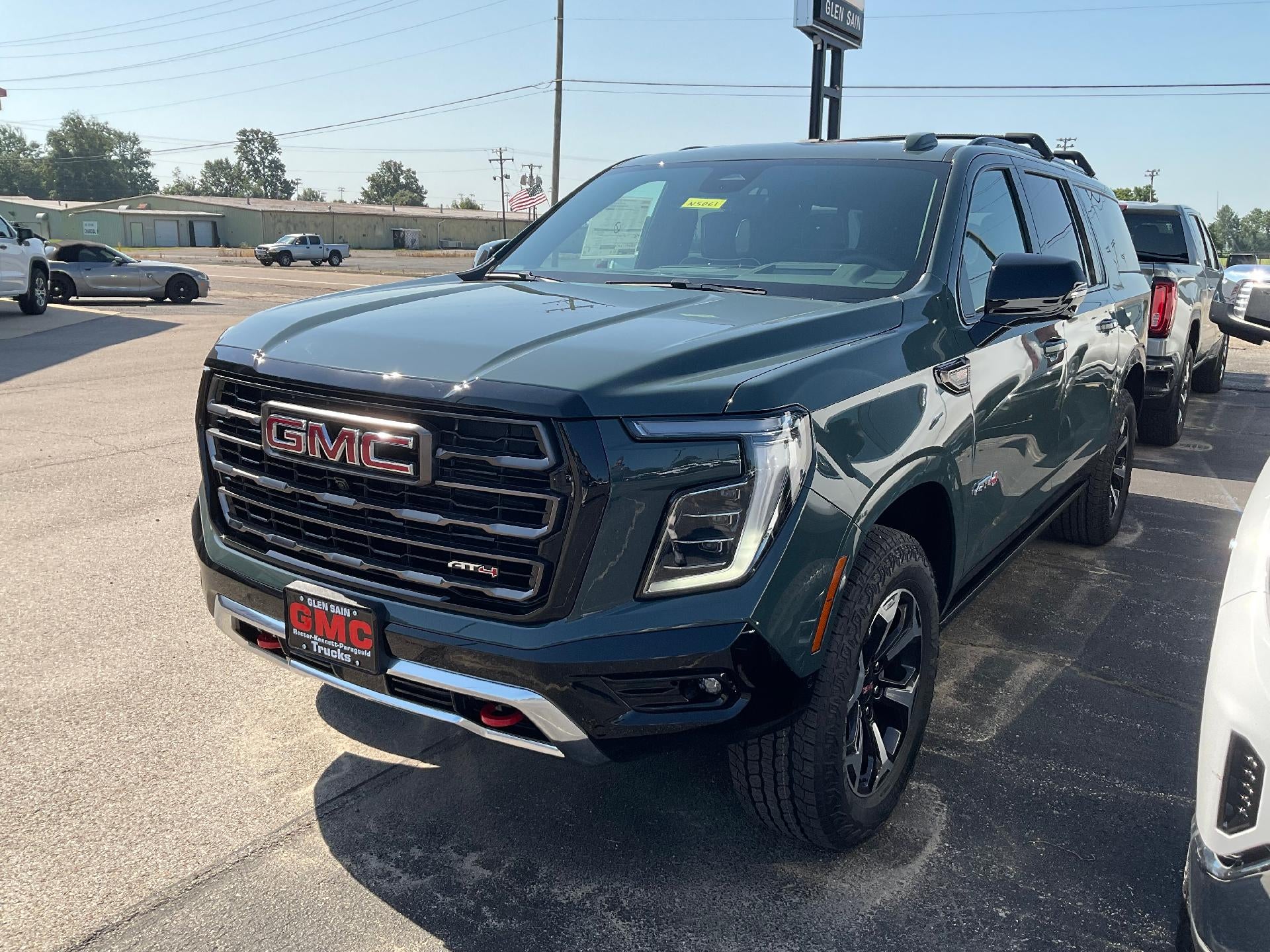 2026 GMC Yukon XL AT4 Ultimate in Midnight Pine — front three-quarter view
