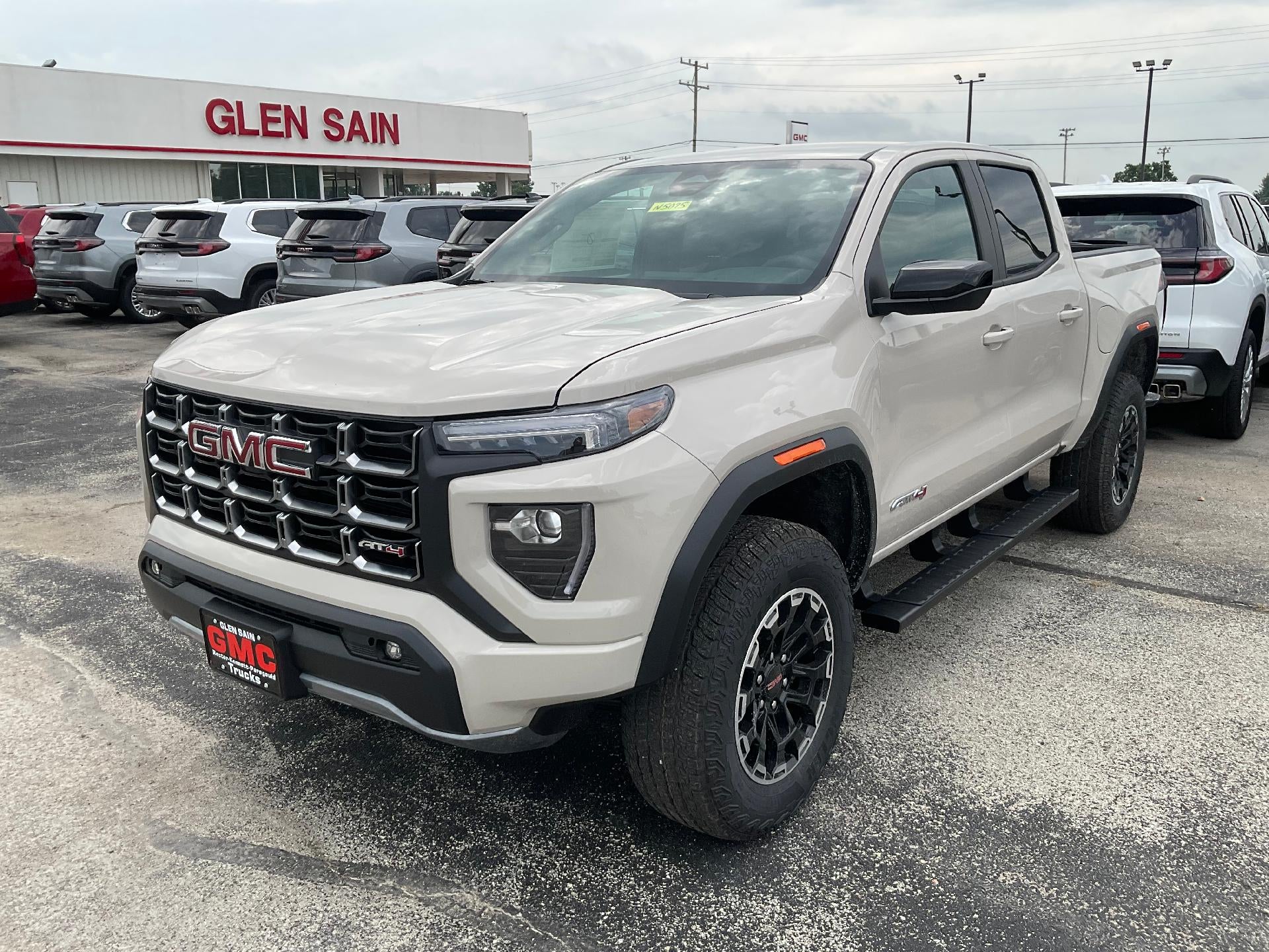 2026 GMC Canyon AT4 in Coastal Dune — front three-quarter view