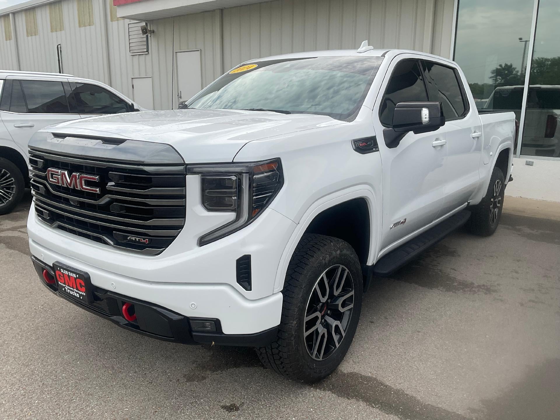 2024 GMC Sierra 1500 AT4 in Summit White — front three-quarter view